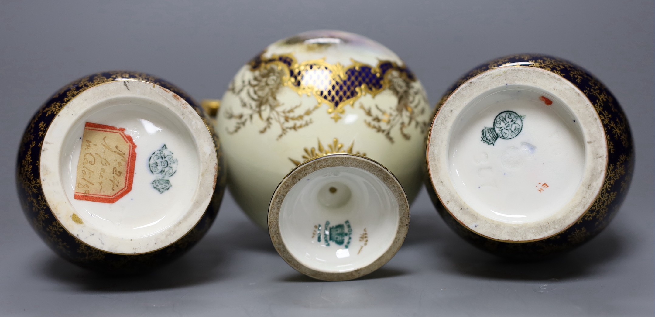 A pair of Royal Worcester bottle vases and a Coalport landscape vignette vase and cover, pair of vases 20 cms high
